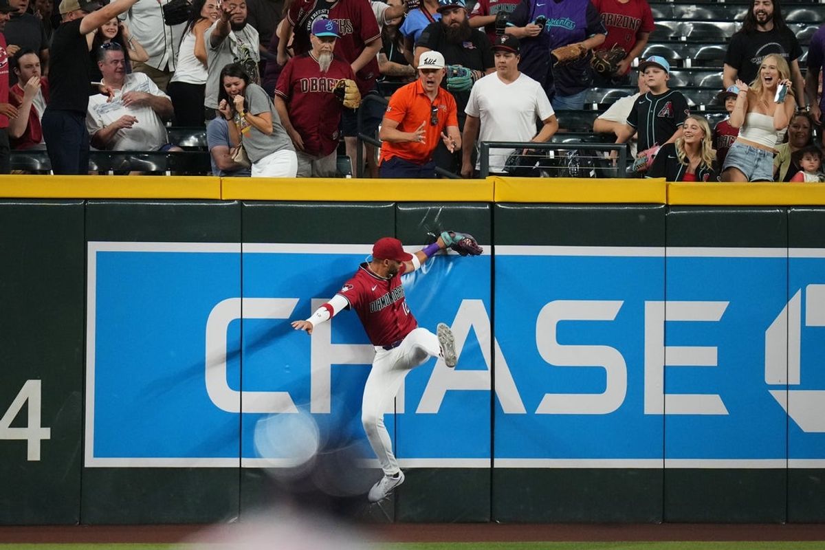 Arizona Diamondbacks outfielder Lourdes Gurriel Jr. (12) catches a fly ball at the wall against the Houston Astros at Chase Field on July 21, 2025.