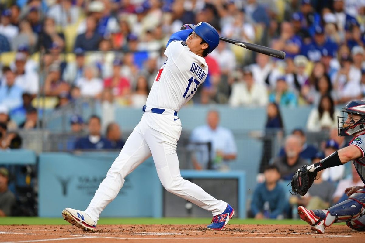 Jul 21, 2025; Los Angeles, California, USA; Los Angeles Dodgers starting pitcher Shohei Ohtani (17) hits a two run home run against the Minnesota Twins during the first inning at Dodger Stadium. Mandatory Credit: Gary A. Vasquez-Imagn Images