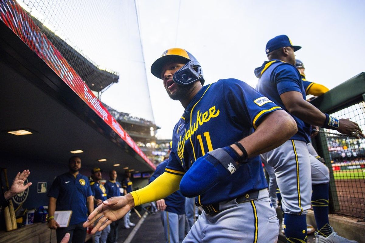 Jul 21, 2025; Seattle, Washington, USA; Milwaukee Brewers right fielder Jackson Chourio (11) celebrates with teammates in the dugout after scoring a run against the Seattle Mariners during the sixth inning at T-Mobile Park. Mandatory Credit: Joe Nicholson-Imagn Images