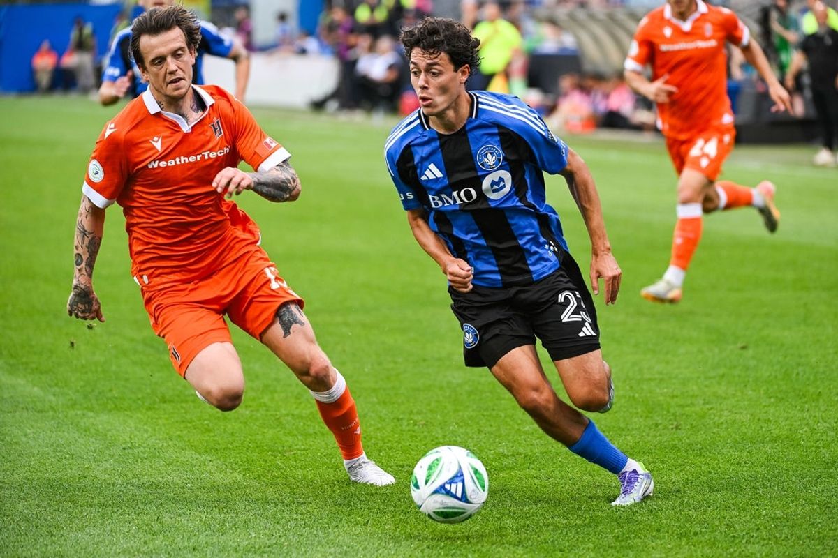 Jul 9, 2025; Montreal, Quebec, CAN; CF Montreal midfielder Caden Clark (23) plays the ball against Forge FC Hamilton midfielder Alexander Achinioti-Jonsson (13) during the first half at Stade Saputo. Mandatory Credit: David Kirouac-Imagn Images
