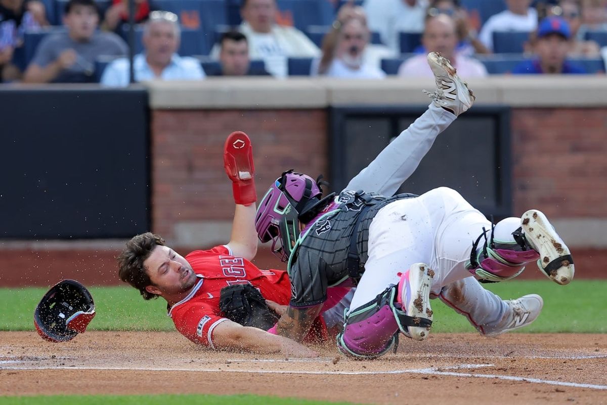 Jul 22, 2025; New York City, New York, USA; New York Mets catcher Francisco Alvarez (4) tags out Los Angeles Angels first baseman Nolan Schanuel (18) trying to score on a single by right fielder Mike Trout (not pictured) during the first inning at Citi Field. Mandatory Credit: Brad Penner-Imagn Images