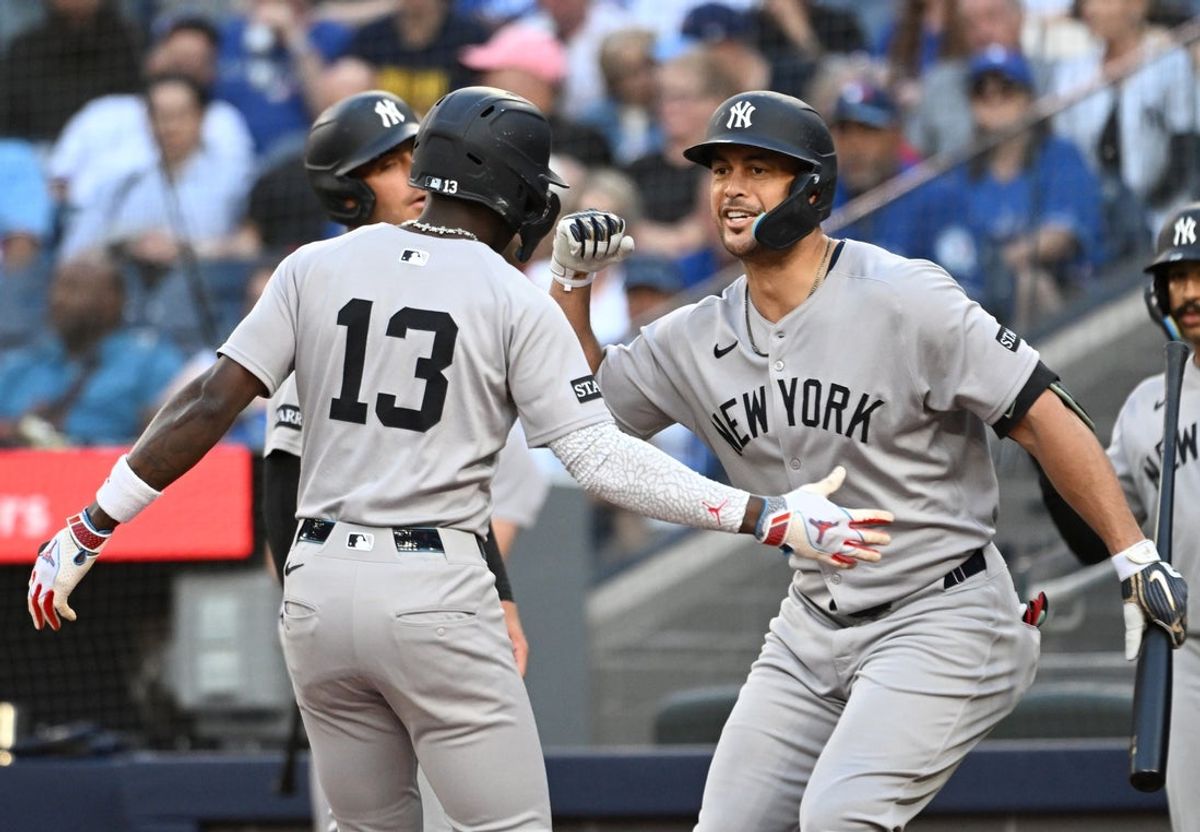 Jul 22, 2025; Toronto, Ontario, CAN;   New York Yankees designated hitter Giancarlo Stanton (27) greets second baseman Jazz Chisholm Jr. (13) who hit a three run home run against the Toronto Blue Jays in the first inning at Rogers Centre. Mandatory Credit: Dan Hamilton-Imagn Images