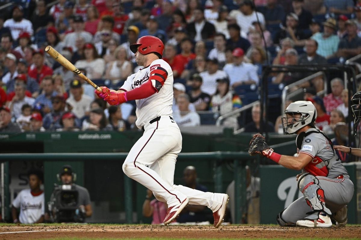 Jul 22, 2025; Washington, District of Columbia, USA; Washington Nationals catcher Riley Adams (15) hits a two RBI single against the Cincinnati Reds during the sixth inning at Nationals Park. Mandatory Credit: Brad Mills-Imagn Images