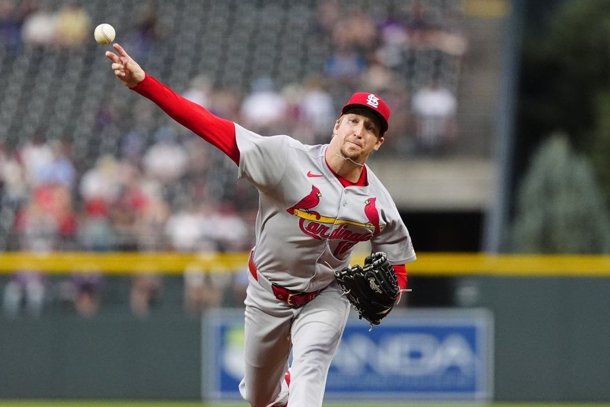 Jul 22, 2025; Denver, Colorado, USA; St. Louis Cardinals starting pitcher Erick Fedde (12) delivers a pitch in the first inning against the Colorado Rockies at Coors Field. Mandatory Credit: Ron Chenoy-Imagn Images