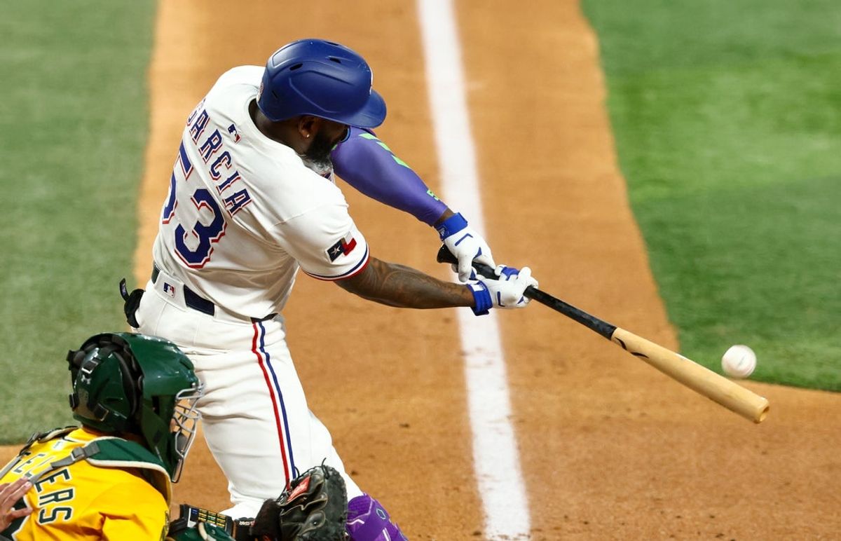 Jul 22, 2025; Arlington, Texas, USA; Texas Rangers right fielder Adolis Garcia (53) hits a home run during the fourth inning against the Athletics at Globe Life Field. Mandatory Credit: Kevin Jairaj-Imagn Images
