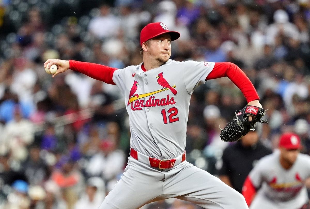 Jul 22, 2025; Denver, Colorado, USA; St. Louis Cardinals starting pitcher Erick Fedde (12) delivers a pitch in the third inning against the Colorado Rockies at Coors Field. Mandatory Credit: Ron Chenoy-Imagn Images