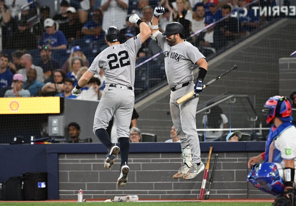 Jul 22, 2025; Toronto, Ontario, CAN;   New York Yankees first baseman Ben Rice (22) celebrates with catcher Austin Well (28) after hitting a solo home run against the Toronto Blue Jays in the ninth inning at Rogers Centre. Mandatory Credit: Dan Hamilton-Imagn Images