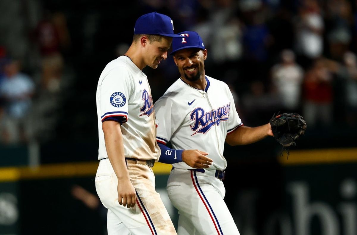 Jul 22, 2025; Arlington, Texas, USA;  Texas Rangers shortstop Corey Seager (5) celebrates with Texas Rangers second baseman Marcus Semien (2) after the game against the Athletics at Globe Life Field. Mandatory Credit: Kevin Jairaj-Imagn Images