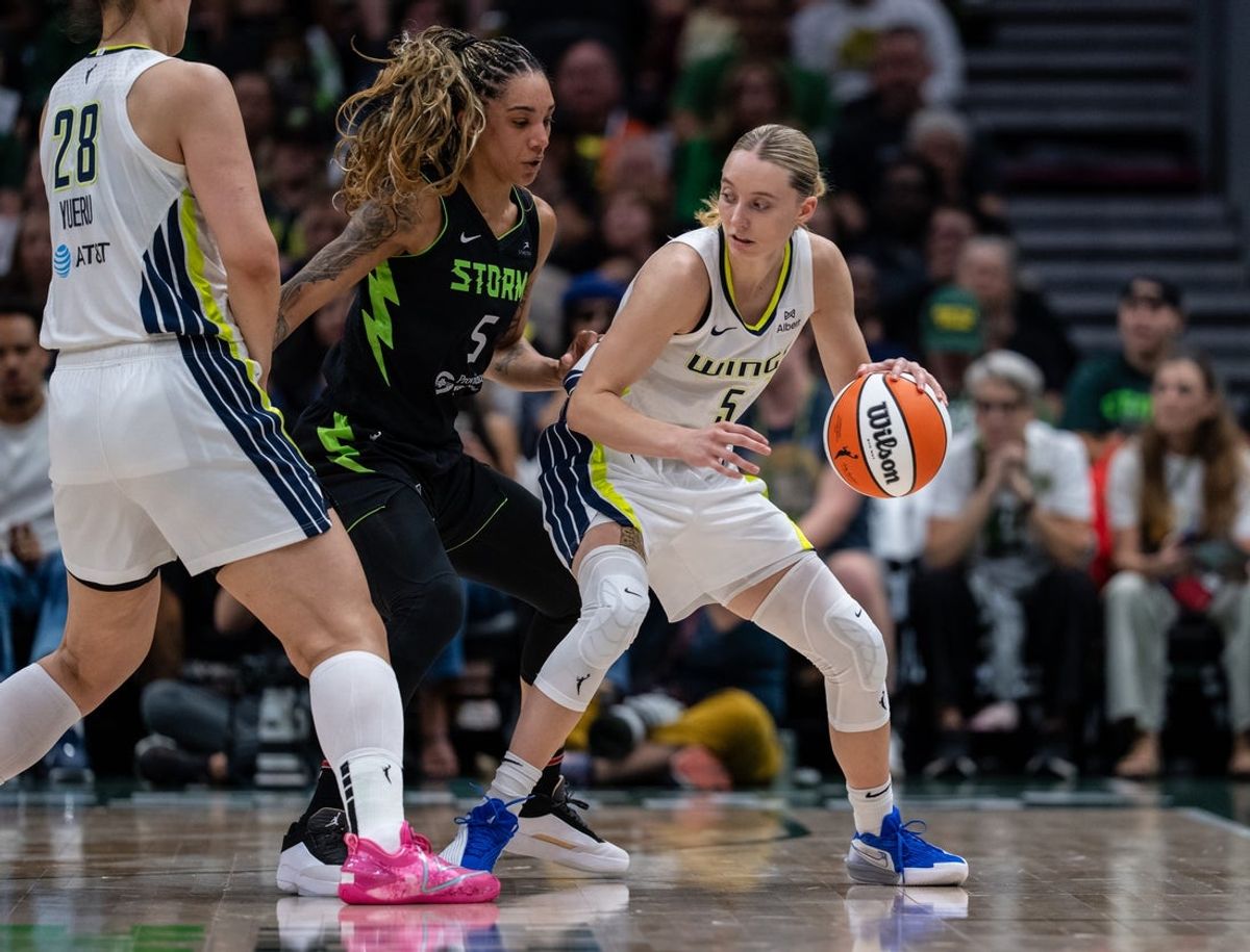 Jul 22, 2025; Seattle, Washington, USA;  Dallas Wings guard Paige Bueckers (5), right, dribbles the ball against Seattle Storm forward Gabby Williams (5) at Climate Pledge Arena. Mandatory Credit: Stephen Brashear-Imagn Images