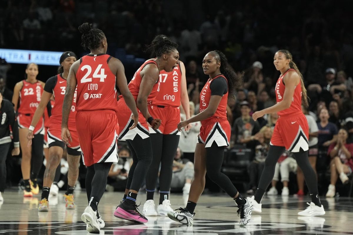 Jul 22, 2025; Las Vegas, Nevada, USA; Las Vegas Aces guard Chelsea Gray (12) reacts to guard Dana Evans (11) during a timeout in the second quarter of their game against the Atlanta Dream at Michelob Ultra Arena. Mandatory Credit: Candice Ward-Imagn Images