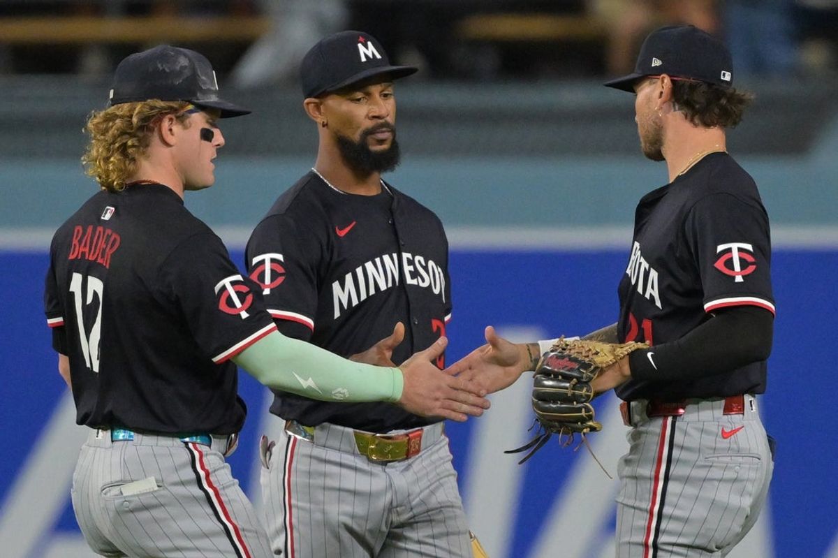 Jul 22, 2025; Los Angeles, California, USA;  Minnesota Twins left fielder Harrison Bader (12), center fielder Byron Buxton (28) and right fielder DaShawn Keirsey Jr. (21) shake hands after the final out of the ninth inning against the Los Angeles Dodgers at Dodger Stadium. Mandatory Credit: Jayne Kamin-Oncea-Imagn Images
