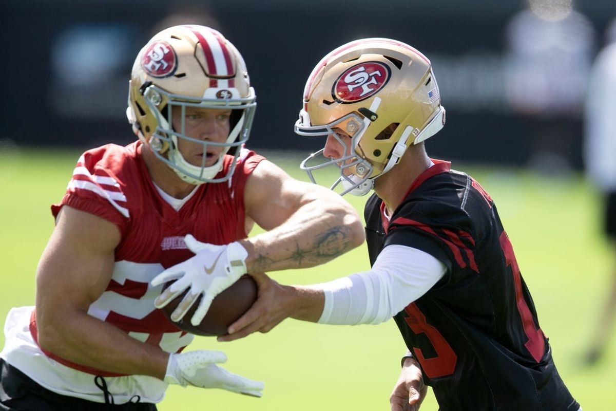 Jul 23, 2025; Santa Clara, CA, USA; San Francisco 49ers quarterback Brock Purdy (13) hands off to running back Christian McCaffrey (23) during the first day of training camp at SAP Performance Facility. Mandatory Credit: D. Ross Cameron-Imagn Images
