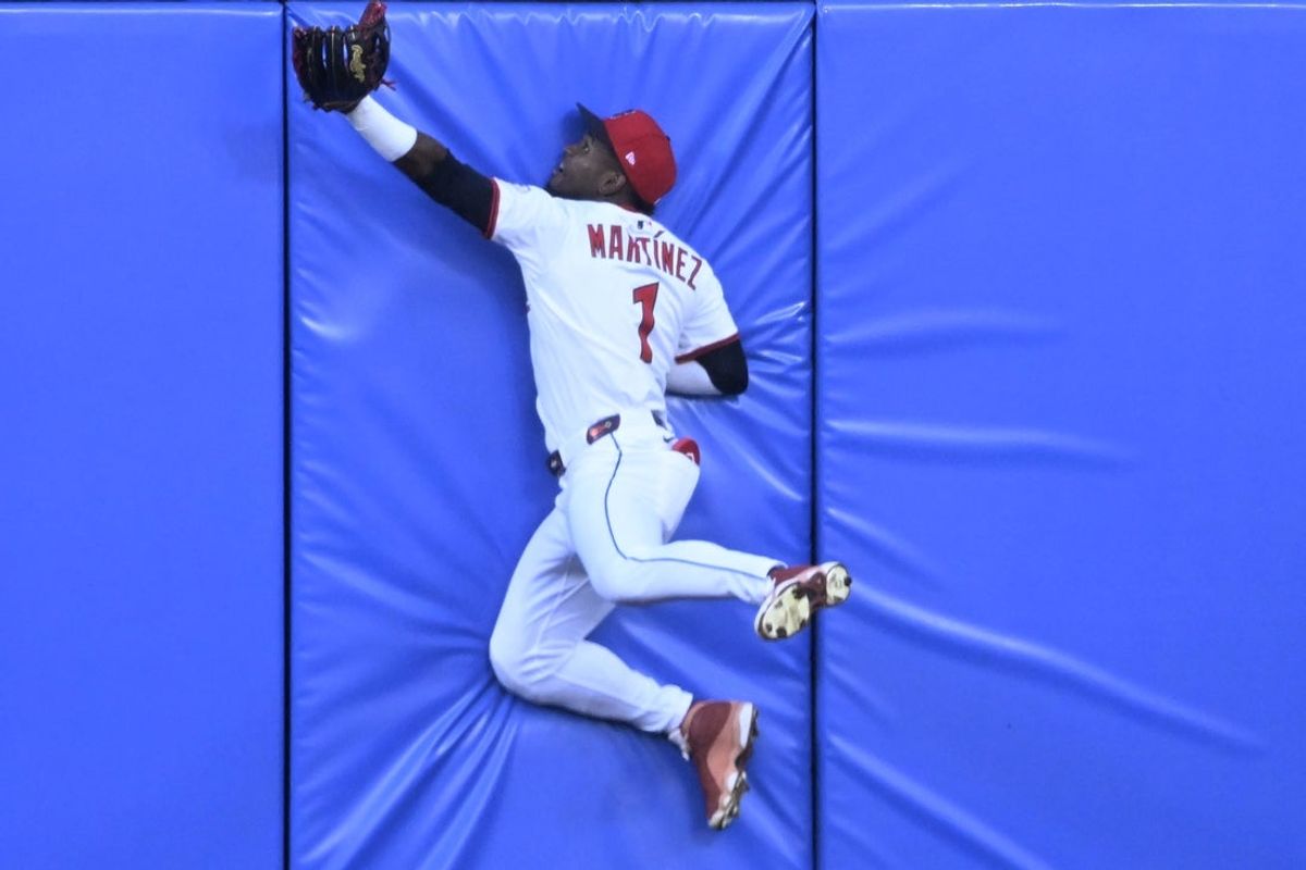 Jul 23, 2025; Cleveland, Ohio, USA; Cleveland Guardians center fielder Angel Martinez (1) collides with the outfield wall while attempting a catch in the fourth inning against the Baltimore Orioles at Progressive Field. Mandatory Credit: David Richard-Imagn Images