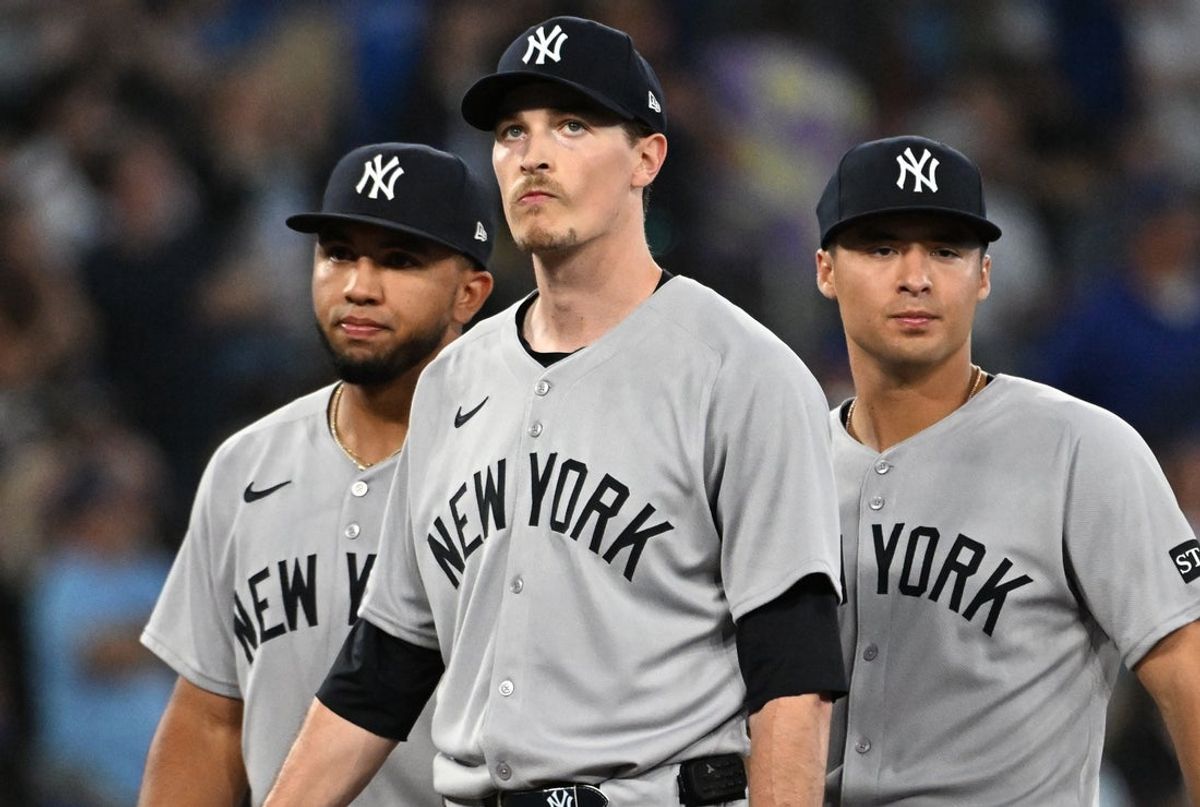 Jul 23, 2025; Toronto, Ontario, CAN;  New York Yankees starting pitcher Max Fried (54) stands between third baseman Oswald Peraza (18, left) and shortstop Anthony Volpe (11) as he waits to be relieved in the sixth inning against the Toronto Blue Jays at Rogers Centre. Mandatory Credit: Dan Hamilton-Imagn Images