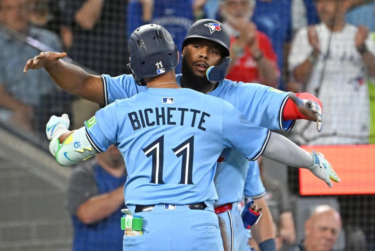 Jul 23, 2025; Toronto, Ontario, CAN;  Toronto Blue Jays shortstop Bo Bichette (11) is greeted by first baseman Vladimir Guerrero Jr. (27) after hitting a two run home run against the New York Yankees in the seventh inning at Rogers Centre. Mandatory Credit: Dan Hamilton-Imagn Images