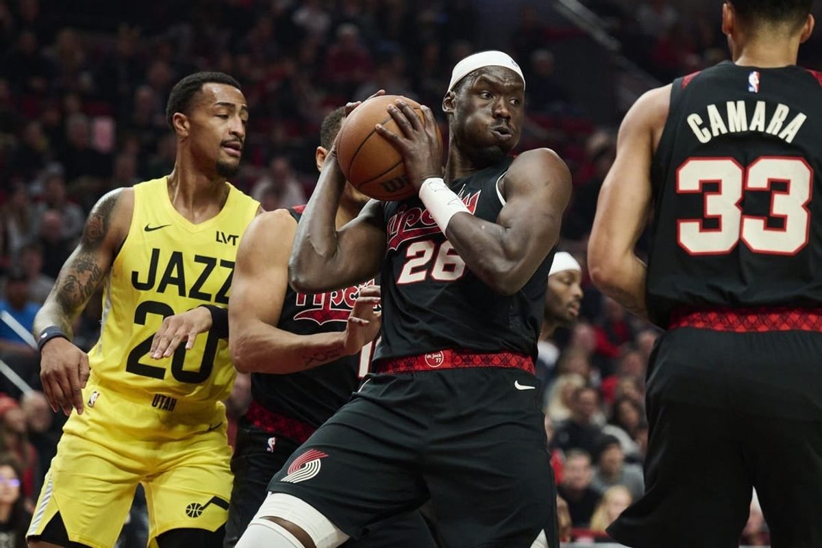Nov 22, 2023; Portland, Oregon, USA; Portland Trail Blazers center Duop Reath (26) grabs an defensive rebound during the first half against the Utah Jazz at Moda Center.