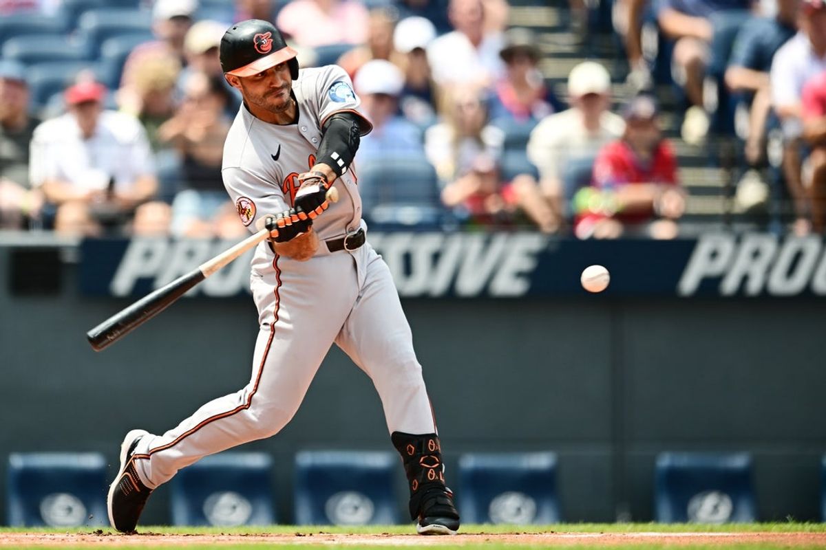 Jul 24, 2025; Cleveland, Ohio, USA; Baltimore Orioles left fielder Ramon Laureano (12) hits a home run during the first inning against the Cleveland Guardians at Progressive Field. Mandatory Credit: Ken Blaze-Imagn Images
