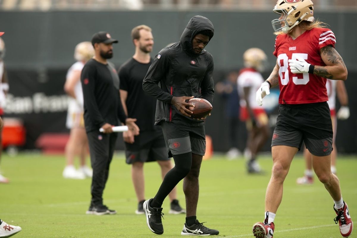 Jul 24, 2025; Santa Clara, CA, USA; Still recovering from knee surgery, San Francisco 49ers wide receiver Brandon Aiyuk (left)  hangs out with teammate George Kittle (85) during the second day of training camp. Mandatory Credit: D. Ross Cameron-Imagn Images