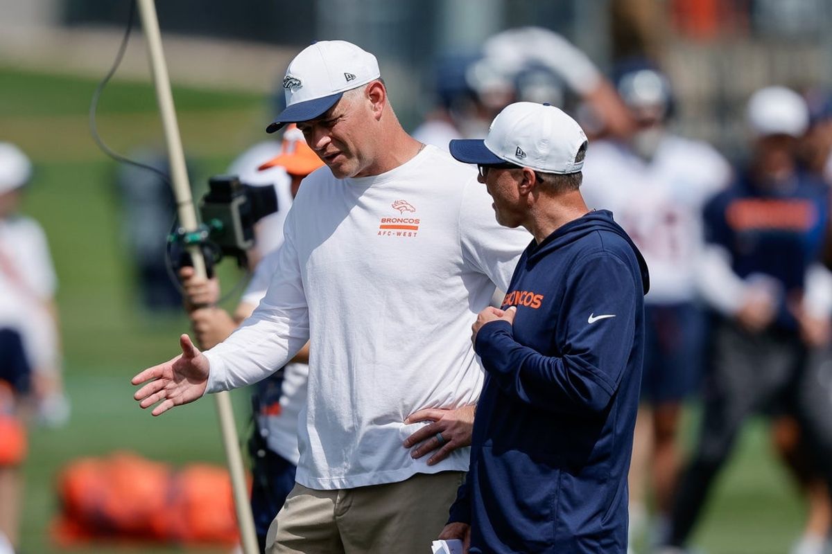 Jul 24, 2025; Englewood, CO, USA; Denver Broncos offensive coordinator Joe Lombardi (L) and offensive assistant Pete Carmichael (R) during Denver Broncos Training Camp. Mandatory Credit: Isaiah J. Downing-Imagn Images