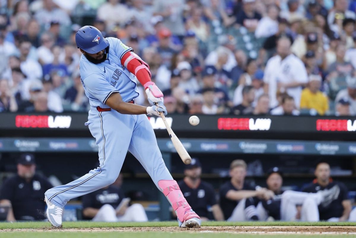 Jul 24, 2025; Detroit, Michigan, USA; Toronto Blue Jays first baseman Vladimir Guerrero Jr. (27) hits a single in the fifth inning against the Detroit Tigers at Comerica Park. Mandatory Credit: Rick Osentoski-Imagn Images