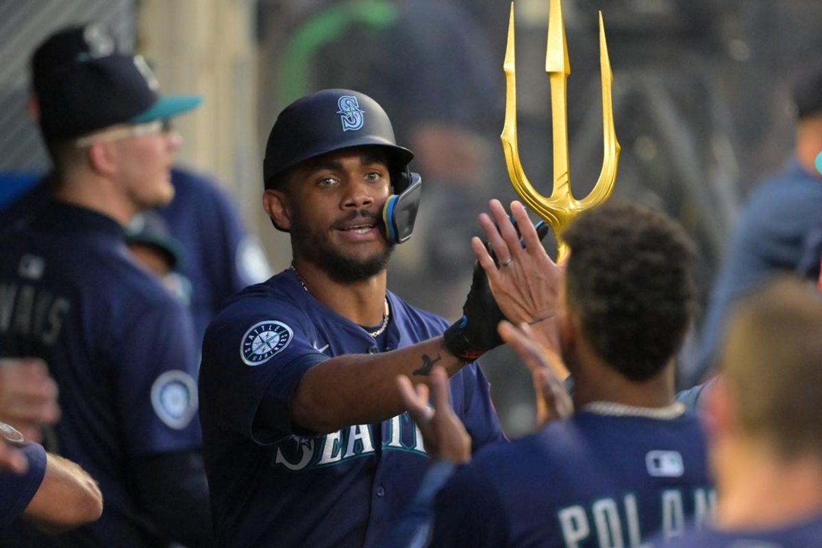 Jul 24, 2025; Anaheim, California, USA;  Seattle Mariners center fielder Julio Rodriguez (44) celebrates in the dugout after hitting a solo home run in the fifth inning against the Los Angeles Angels at Angel Stadium. Mandatory Credit: Jayne Kamin-Oncea-Imagn Images