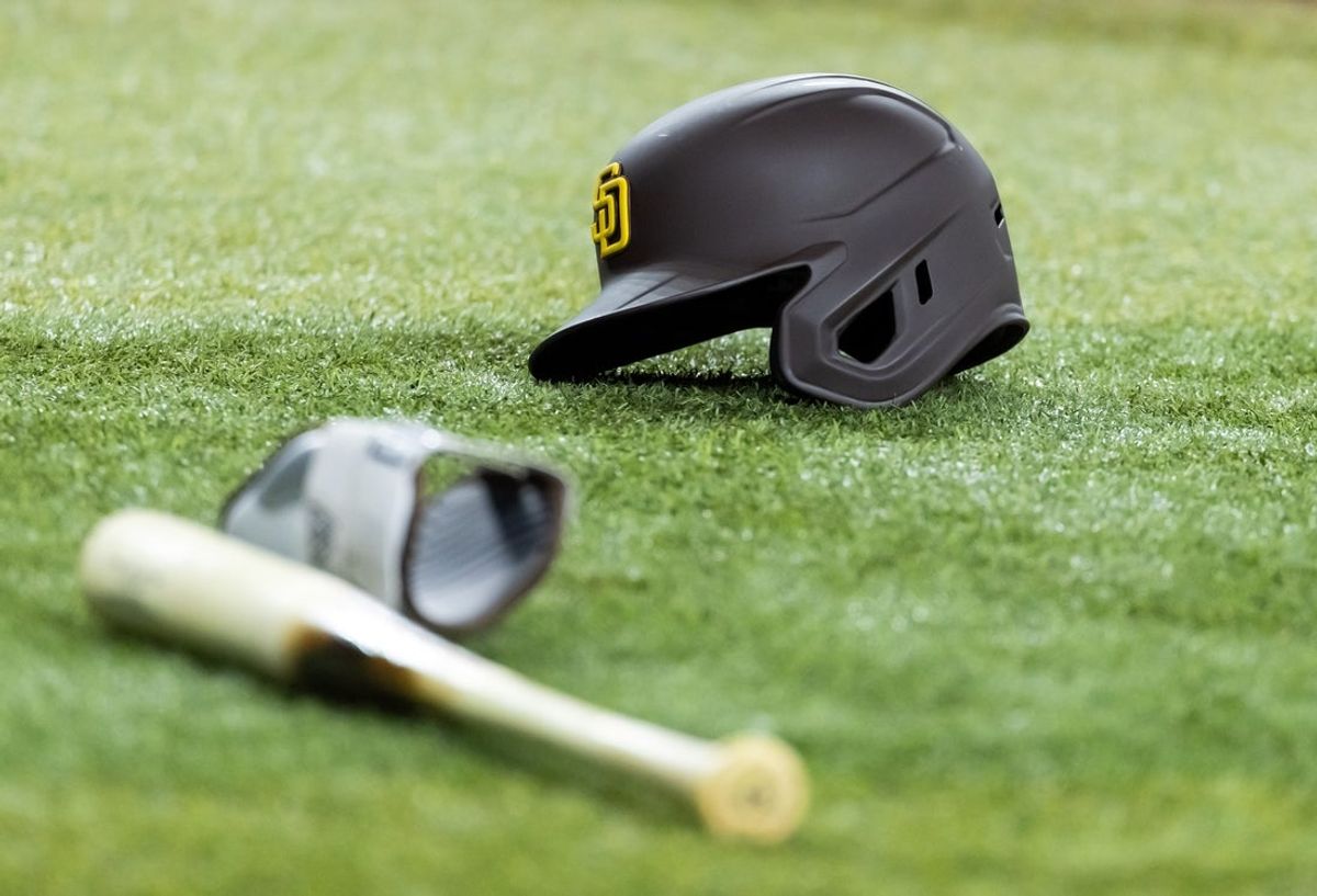 Jun 13, 2025; Phoenix, Arizona, USA; Detailed view of a San Diego Padres batting helmet and baseball bat on the field at Chase Field. Mandatory Credit: Mark J. Rebilas-Imagn Images