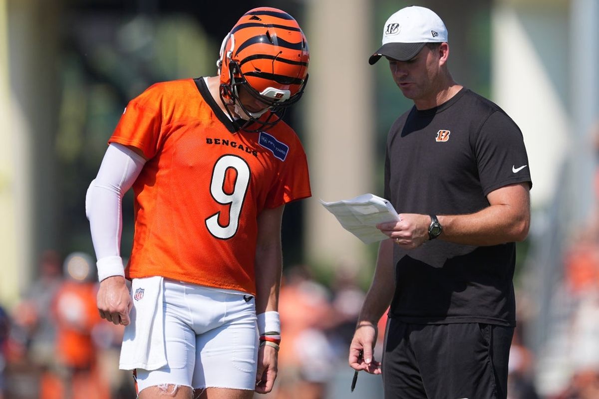 Jul 25, 2025; Cincinnati, OH, USA; Cincinnati Bengals quarterback Joe Burrow (9), left, talks with head coach Zac Taylor, right, during training camp practice. Mandatory Credit: Kareem Elgazzar-Imagn Images