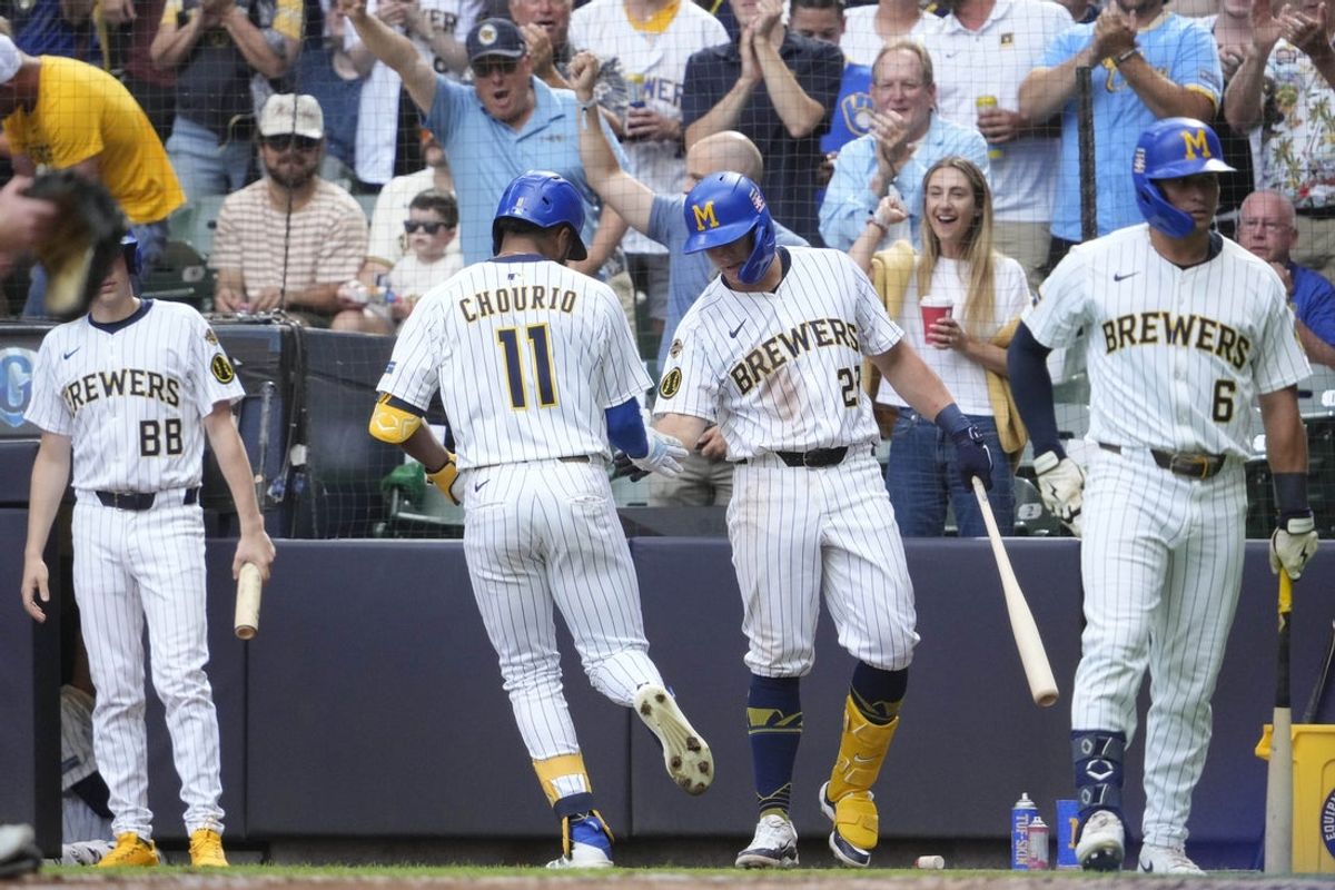 Jul 25, 2025; Milwaukee, Wisconsin, USA; Milwaukee Brewers outfielder Jackson Chourio (11) is congratulated by first base Andrew Vaughn (28) while rounding the bases after hitting a home run against the Miami Marlins in the fourth at American Family Field. Mandatory Credit: Michael McLoone-Imagn Images