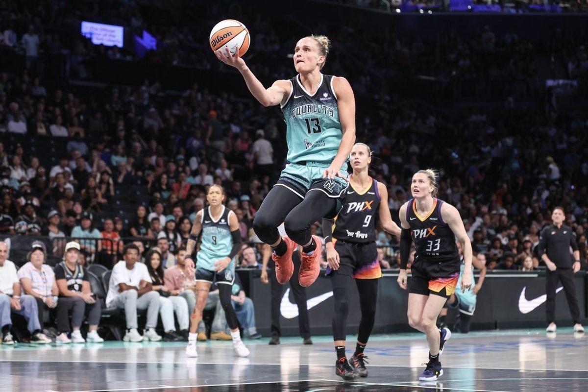 Jul 25, 2025; Brooklyn, New York, USA;  New York Liberty forward Leonie Fiebich (13) drives to the basket in the first quarter against the Phoenix Mercury at Barclays Center. Mandatory Credit: Wendell Cruz-Imagn Images