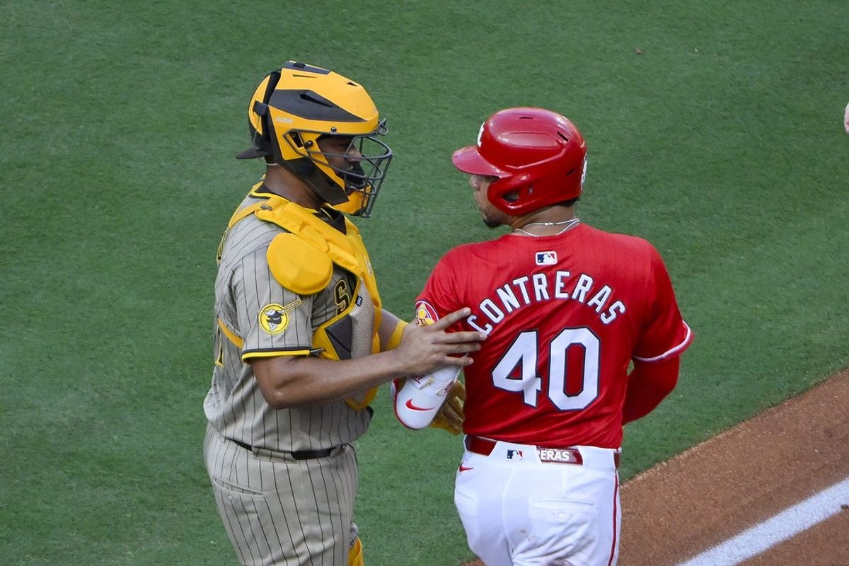 Jul 25, 2025; St. Louis, Missouri, USA;  St. Louis Cardinals first baseman Willson Contreras (40) is held back by San Diego Padres third baseman Jose Iglesias (7) after he was hit by a pitch from starting pitcher Nick Pivetta (not pictured) during the second inning at Busch Stadium. Mandatory Credit: Jeff Curry-Imagn Images