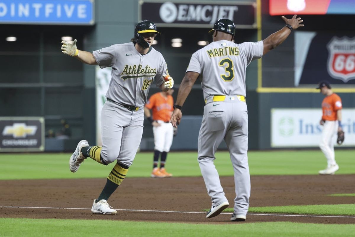 Jul 25, 2025; Houston, Texas, USA;  Athletics designated hitter Nick Kurtz (16) celebrates with third base coach Eric Martins (3) after hitting a home run during the second inning against the Houston Astros at Daikin Park. Mandatory Credit: Troy Taormina-Imagn Images