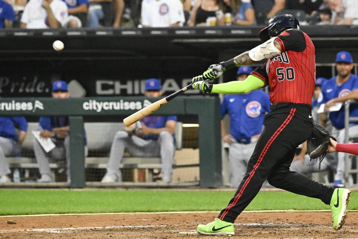 Jul 25, 2025; Chicago, Illinois, USA;  Chicago White Sox second baseman Lenyn Sosa (50) hits a sacrifice fly RBI against the Chicago Cubs during the fourth inning at Rate Field. Mandatory Credit: Matt Marton-Imagn Images