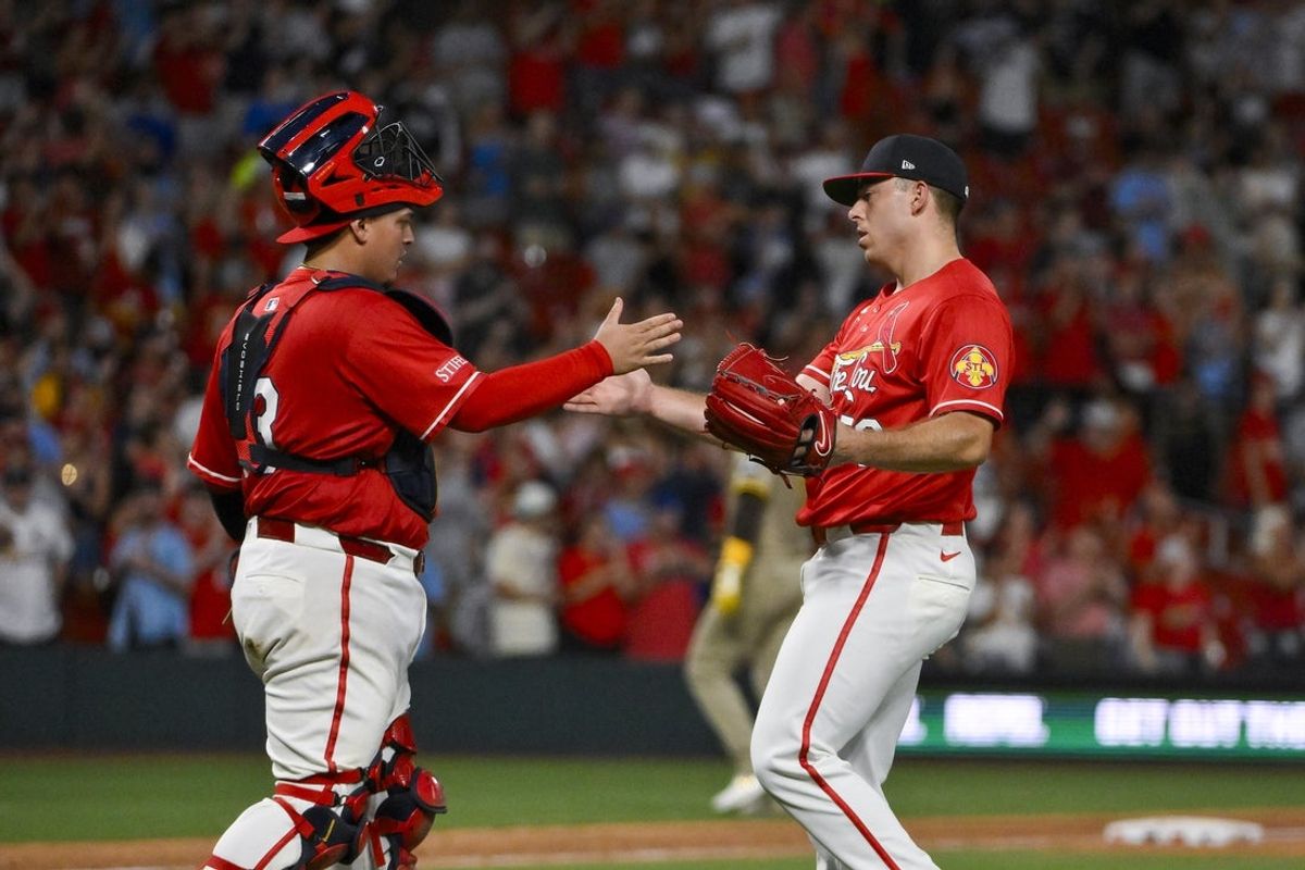 Jul 25, 2025; St. Louis, Missouri, USA;  St. Louis Cardinals relief pitcher Ryan Helsley (56) celebrates with catcher Yohel Pozo (63) after the Cardinals defeated the San Diego Padres at Busch Stadium. Mandatory Credit: Jeff Curry-Imagn Images
