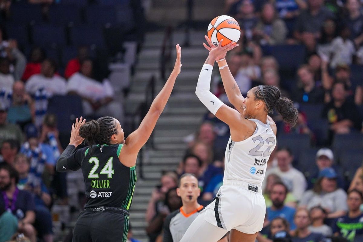 Jul 25, 2025; Minneapolis, Minnesota, USA; Las Vegas Aces center A'ja Wilson (22) shoots against the Minnesota Lynx forward Napheesa Collier (24) in the third quarter at Target Center. Mandatory Credit: Brad Rempel-Imagn Images