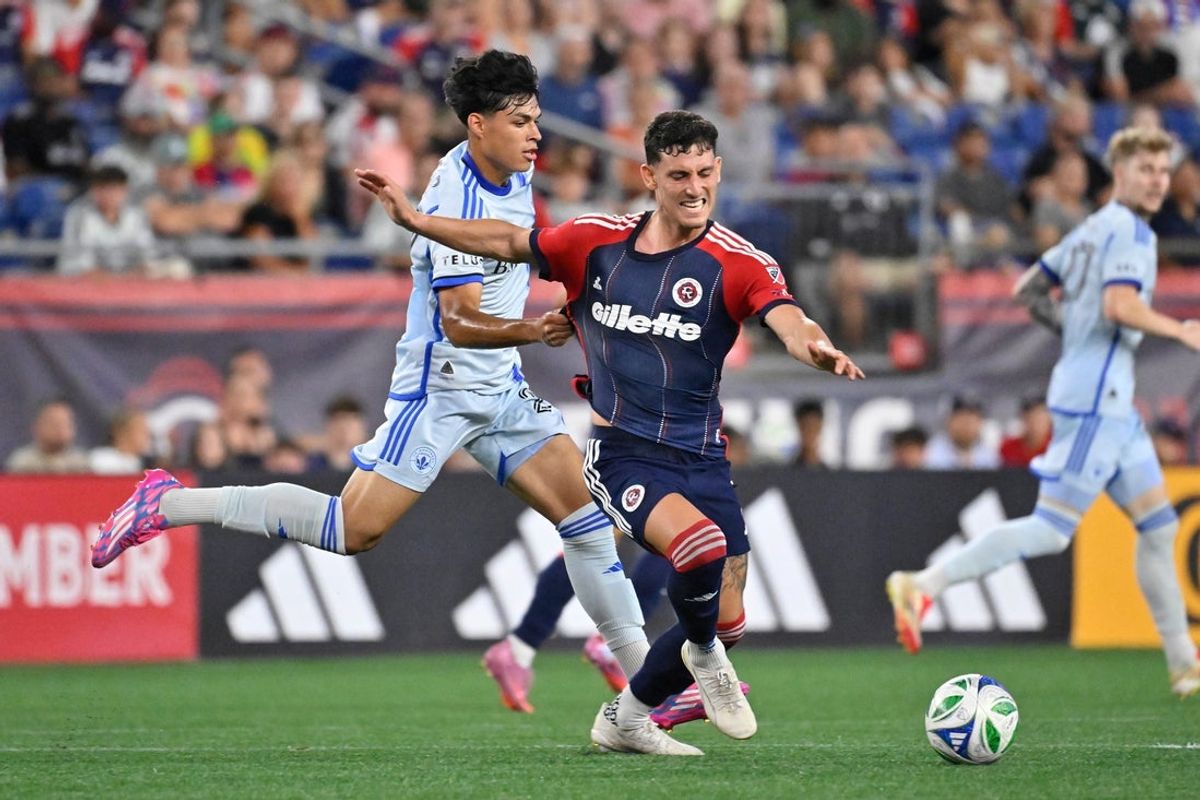 Jul 25, 2025; Foxborough, Massachusetts, USA; CF Montreal midfielder Olger Escobar (29) holds New England Revolution forward Tomas Chancalay (7) during the second half at Gillette Stadium. Mandatory Credit: Eric Canha-Imagn Images