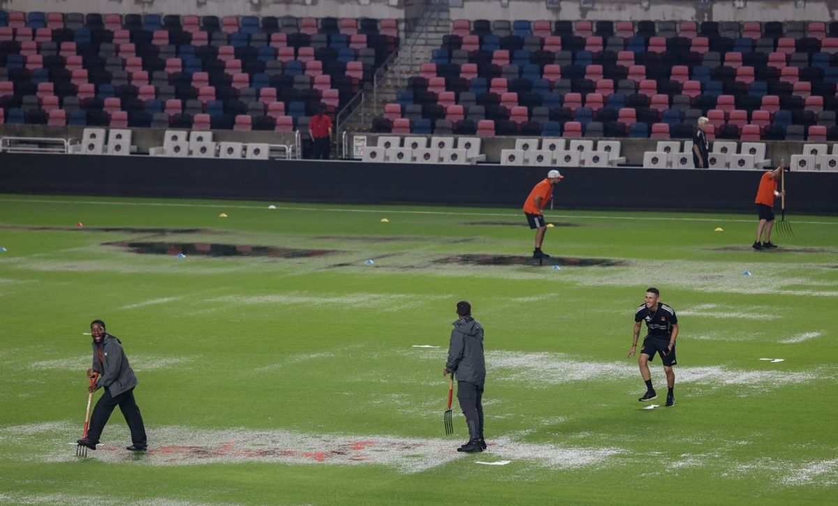 Jul 25, 2025; Houston, Texas, USA;  Grounds crews work on the pitch before the Houston Dynamo FC play against the Los Angeles Galaxy at Shell Energy Stadium. The game was suspended because of severe weather. Mandatory Credit: Thomas Shea-Imagn Images