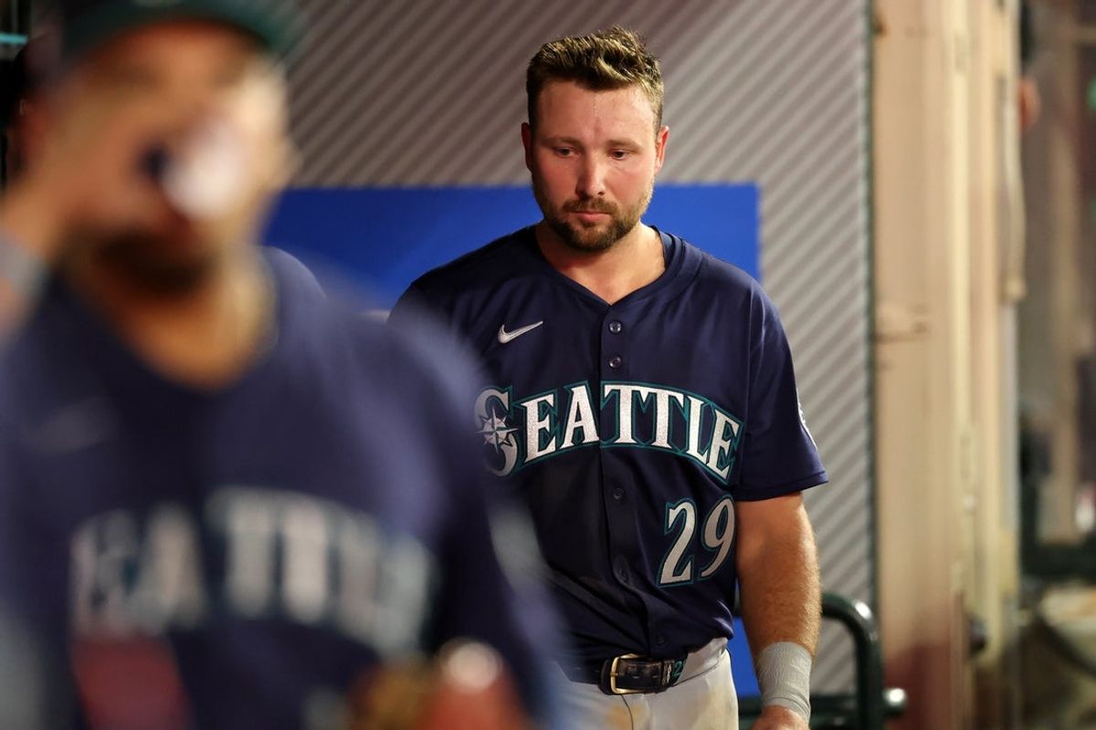 Jul 25, 2025; Anaheim, California, USA;  Seattle Mariners catcher Cal Raleigh (29) looks down in a dugout after striking out during the tenth inning against the Los Angeles Angels at Angel Stadium. Mandatory Credit: Kiyoshi Mio-Imagn Images