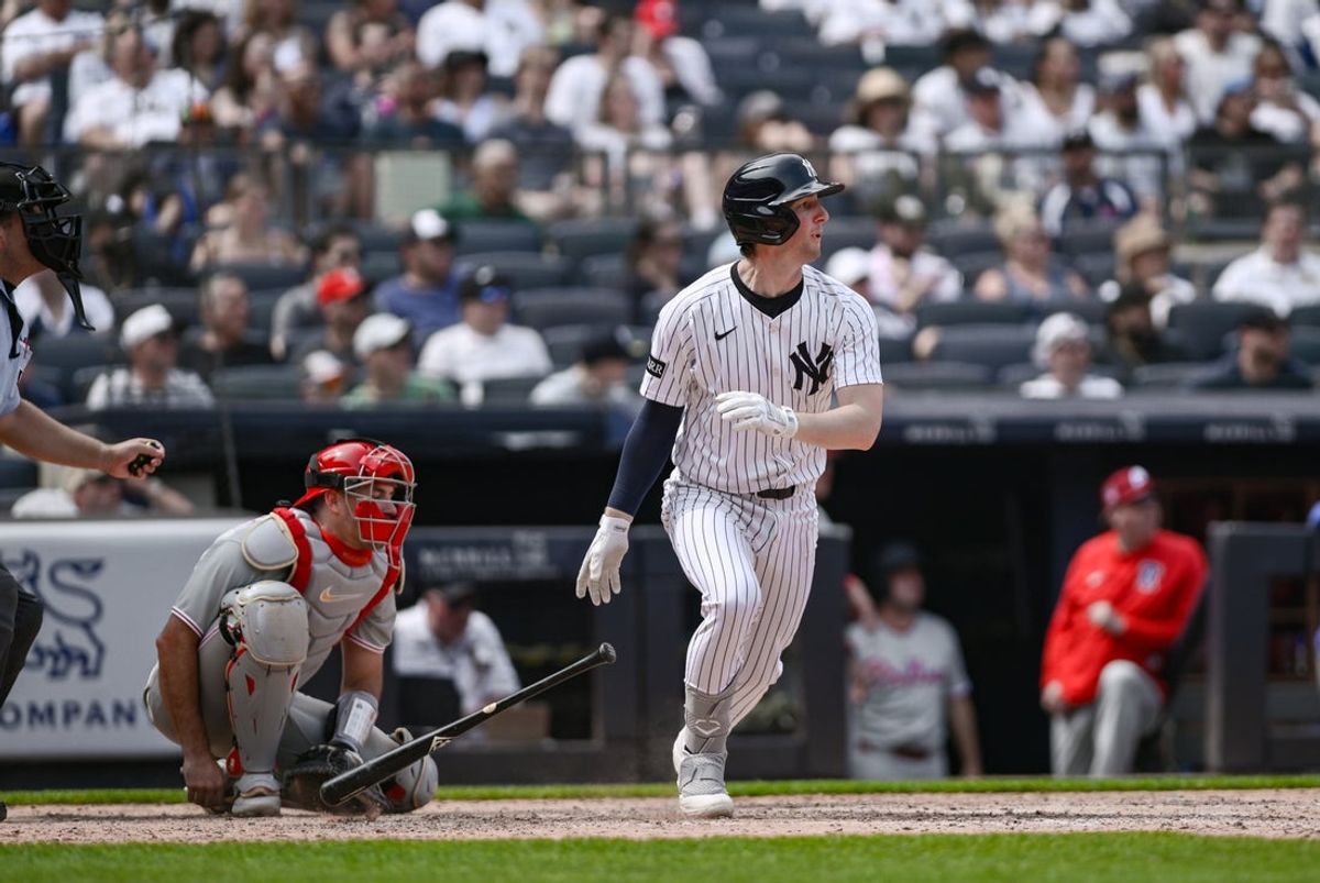 Jul 26, 2025; Bronx, New York, USA; New York Yankees third baseman Ryan McMahon (19) hits a single against the Philadelphia Phillies during the sixth inning at Yankee Stadium. Mandatory Credit: John Jones-Imagn Images