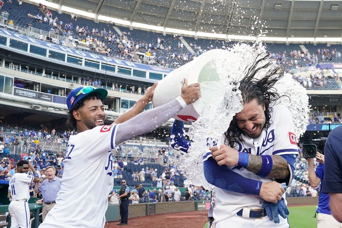 Jul 26, 2025; Kansas City, Missouri, USA; Kansas City Royals designated hitter Jonathan India (6) is doused by left fielder MJ Melendez (1) after hitting a three run walk off home run against the Cleveland Guardians in the tenth inning at Kauffman Stadium. Mandatory Credit: Denny Medley-Imagn Images