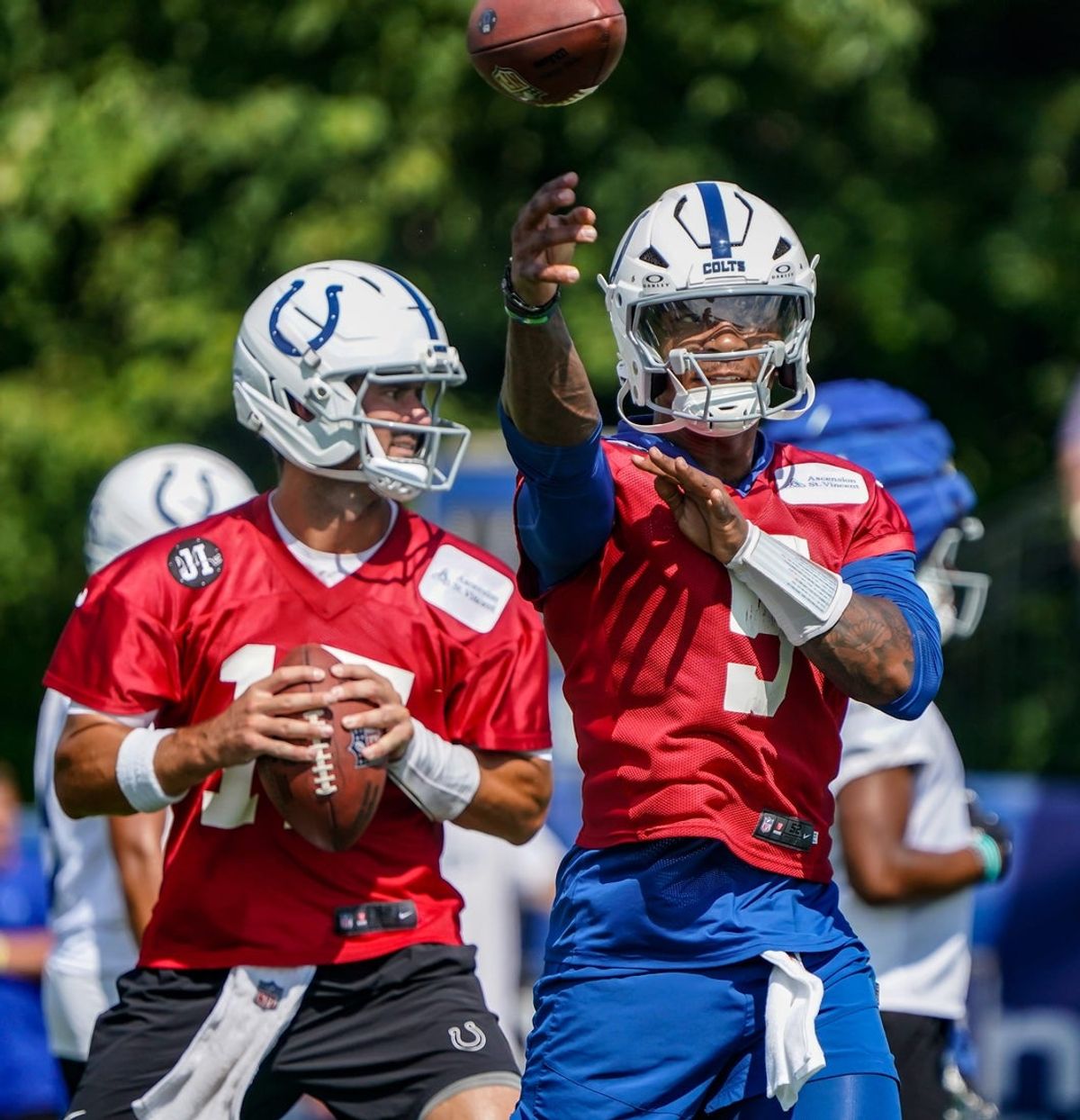 Indianapolis Colts players Daniel Jones (17) and Anthony Richardson Sr. (5) throw passes during the Colts training camp at Grand Park on Saturday, July 26, 2025, in Westfield, Ind.