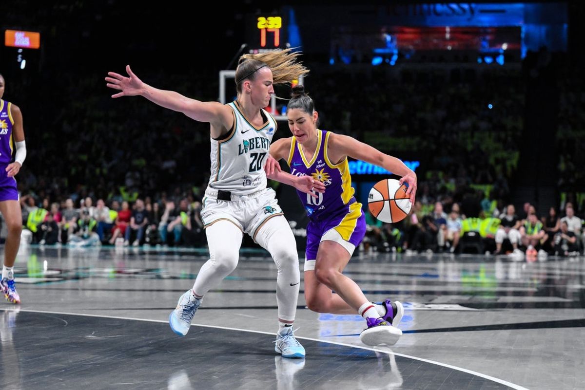 Jul 26, 2025; Brooklyn, New York, USA; Los Angeles Sparks guard Kelsey Plum (10) drives to the basket as New York Liberty guard Sabrina Ionescu (20) defends during the first half at Barclays Center. Mandatory Credit: John Jones-Imagn Images