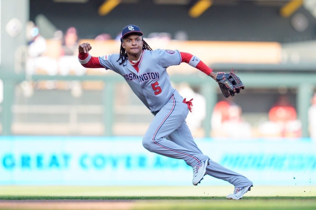 Jul 26, 2025; Minneapolis, Minnesota, USA; Washington Nationals shortstop CJ Abrams (5) jumps at a ball hit by Minnesota Twins shortstop Carlos Correa (4) who will reach first base on the play in the first inning at Target Field. Mandatory Credit: Matt Blewett-Imagn Images