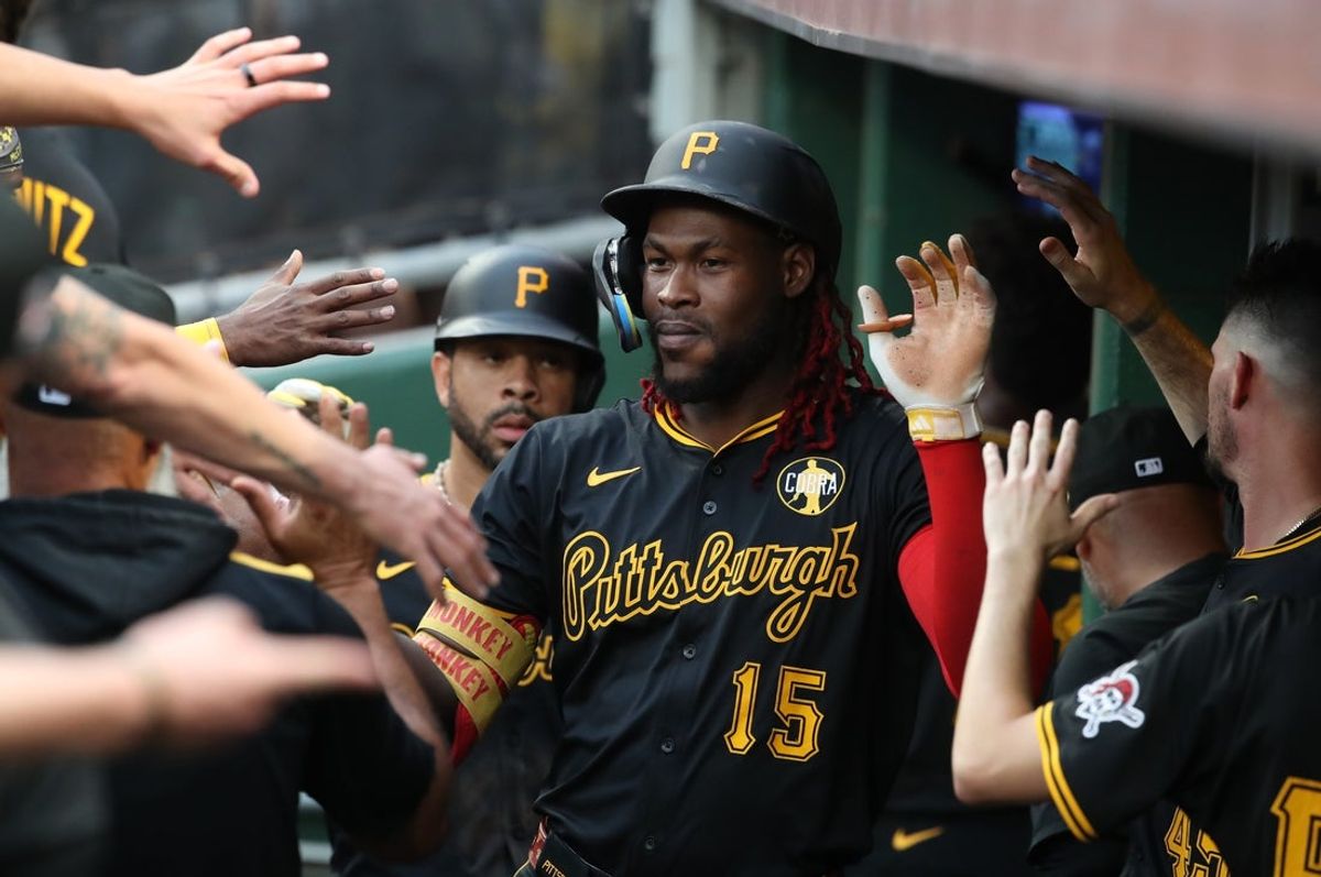 Jul 26, 2025; Pittsburgh, Pennsylvania, USA;  Pittsburgh Pirates center fielder Oneil Cruz (15) celebrates his two run home run in the dugout against the Arizona Diamondbacks during the second inning at PNC Park. Mandatory Credit: Charles LeClaire-Imagn Images