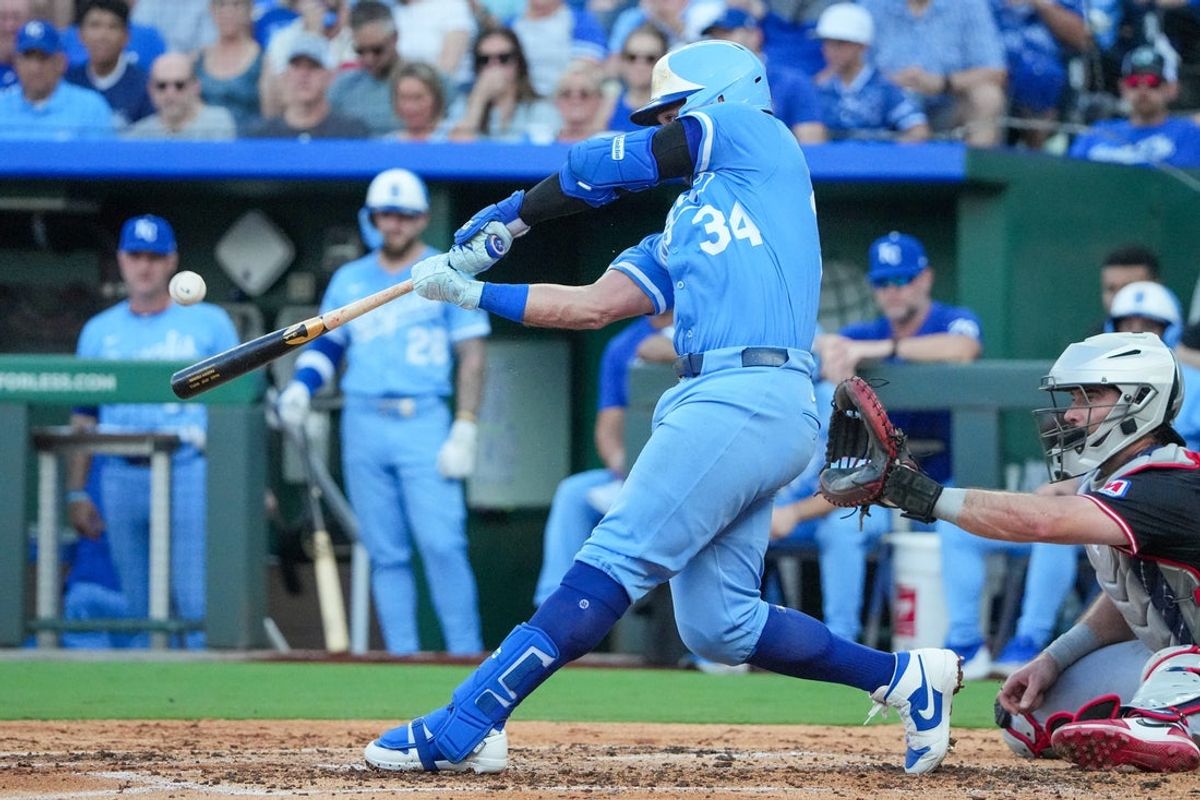 Jul 26, 2025; Kansas City, Missouri, USA; Kansas City Royals catcher Freddy Fermin (34) hits a two run home run against the Cleveland Guardians in the second inning at Kauffman Stadium. Mandatory Credit: Denny Medley-Imagn Images
