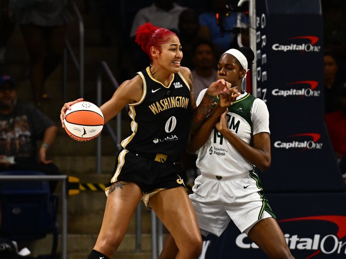 Jul 26, 2025; Washington, District of Columbia, USA;  Washington Mystics forward Shakira Austin (0) fights for position against Seattle Storm center Dominique Malonga (14) during the first quarter at CareFirst Arena. Mandatory Credit: James A. Pittman-Imagn Images
