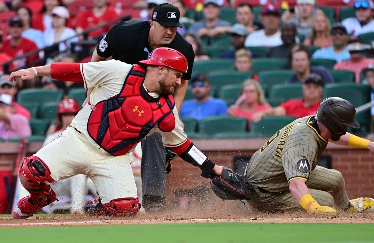 Jul 26, 2025; St. Louis, Missouri, USA;  San Diego Padres first baseman Jake Cronenworth (9) is safe at home plate as St. Louis Cardinals catcher Pedro Pages (43) is late to put the tag on him in the fourth inning at Busch Stadium. Mandatory Credit: Tim Vizer-Imagn Images