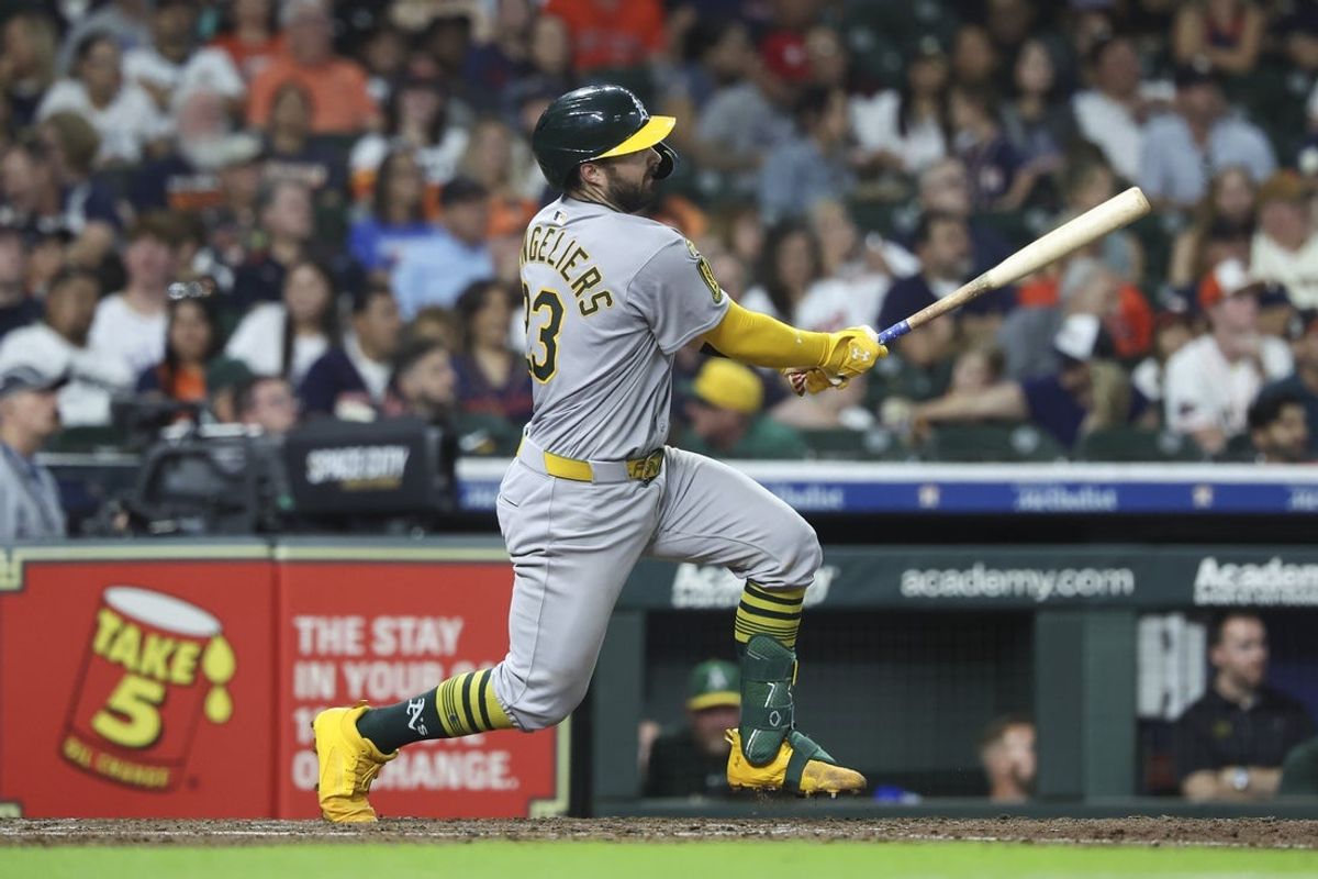 Jul 26, 2025; Houston, Texas, USA; Athletics catcher Shea Langeliers (23) hits a home run during the sixth inning against the Houston Astros at Daikin Park. Mandatory Credit: Troy Taormina-Imagn Images