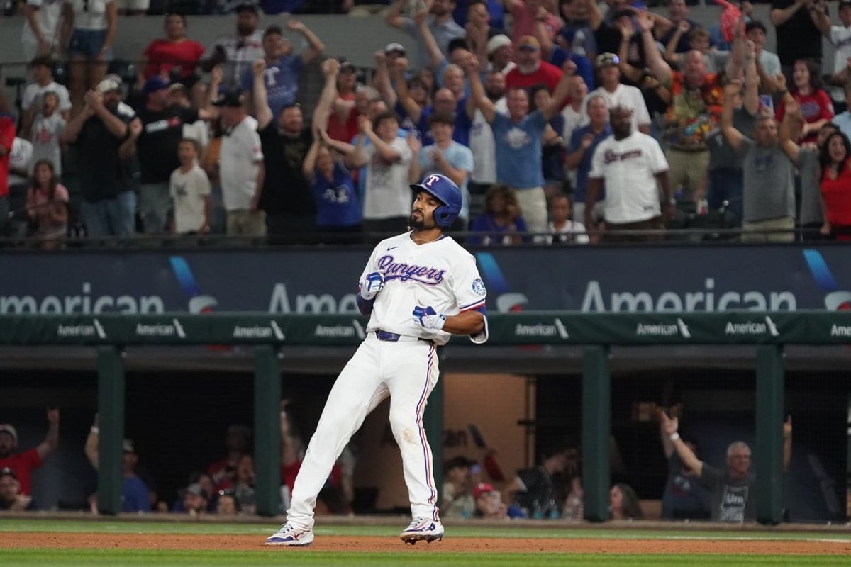 Jul 26, 2025; Arlington, Texas, USA; Texas Rangers second baseman Marcus Semien (2) rounds first base after hitting a walk-off RBI single during the tenth inning against the Atlanta Braves at Globe Life Field. Mandatory Credit: Raymond Carlin III-Imagn Images