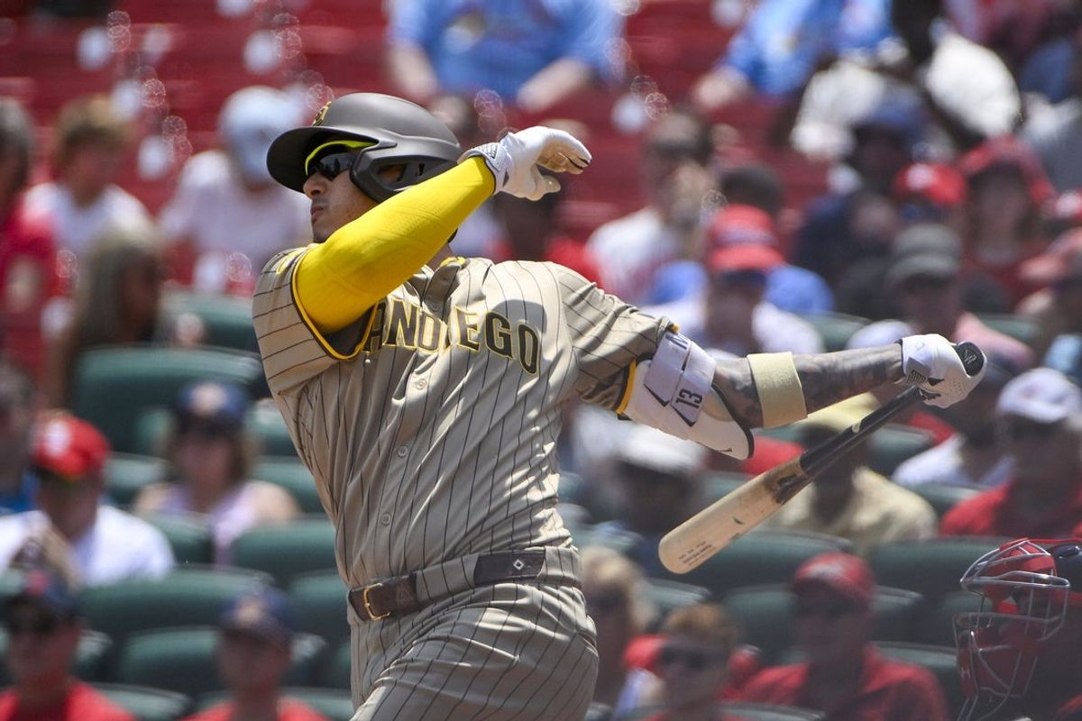 Jul 27, 2025; St. Louis, Missouri, USA;  San Diego Padres third baseman Manny Machado (13) hits a one run double against the St. Louis Cardinals during the first inning at Busch Stadium. Mandatory Credit: Jeff Curry-Imagn Images