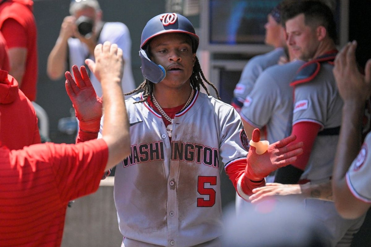Jul 27, 2025; Minneapolis, Minnesota, USA;  Washington Nationals infielder C.J. Abrams (5) celebrates scoring a run against the Minnesota Twins third inning at Target Field. Mandatory Credit: Nick Wosika-Imagn Images